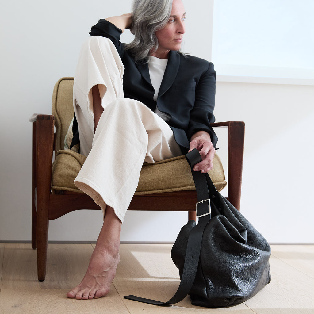 model sitting beside a large central boho 