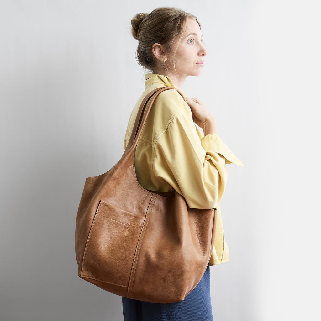 model wearing candid tote in premiums addle 
