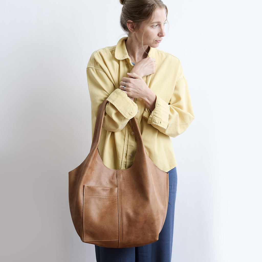 model wearing candid tote in premiums addle 