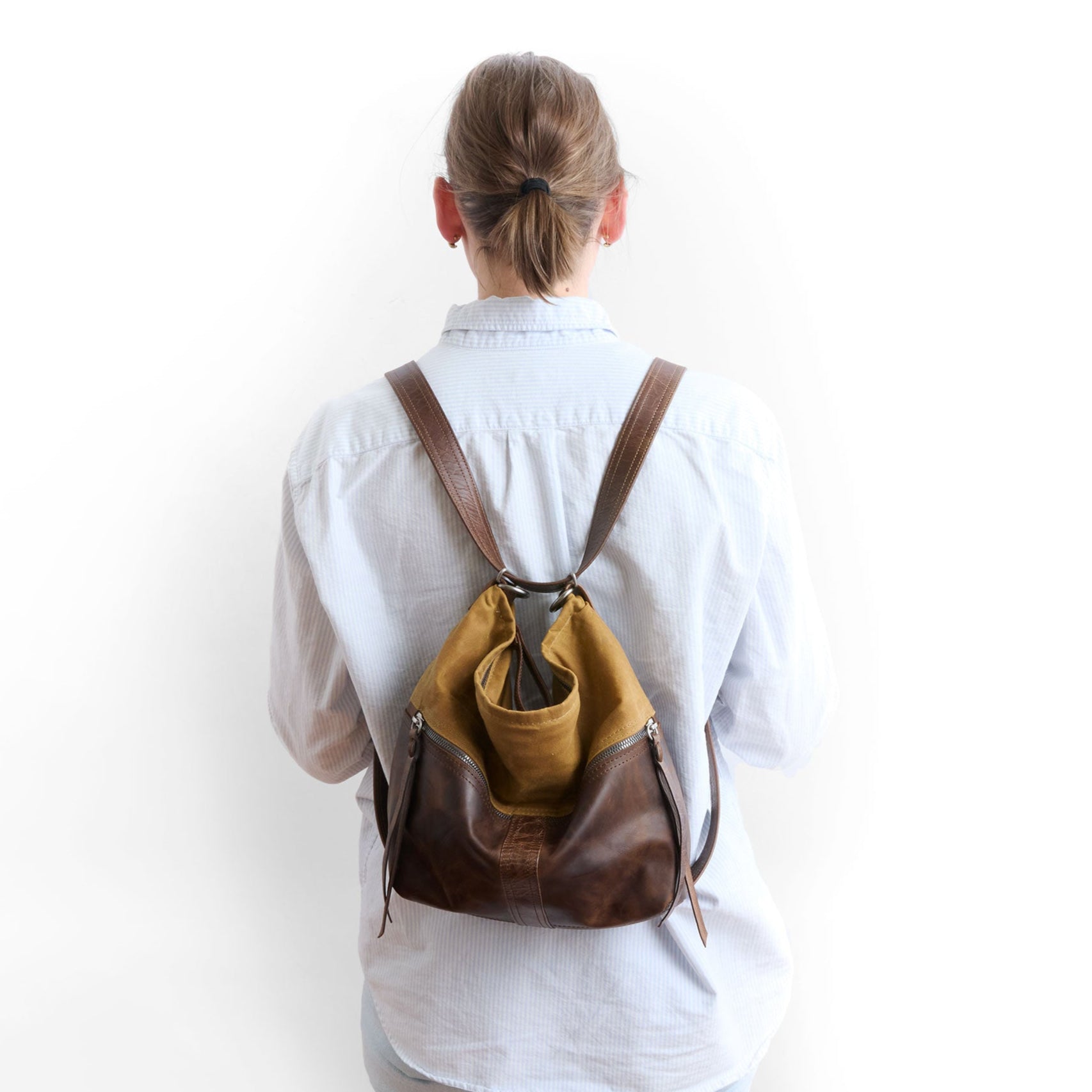 medium city safari double zip in whiskey canvas and rustic pecan in backpack mode