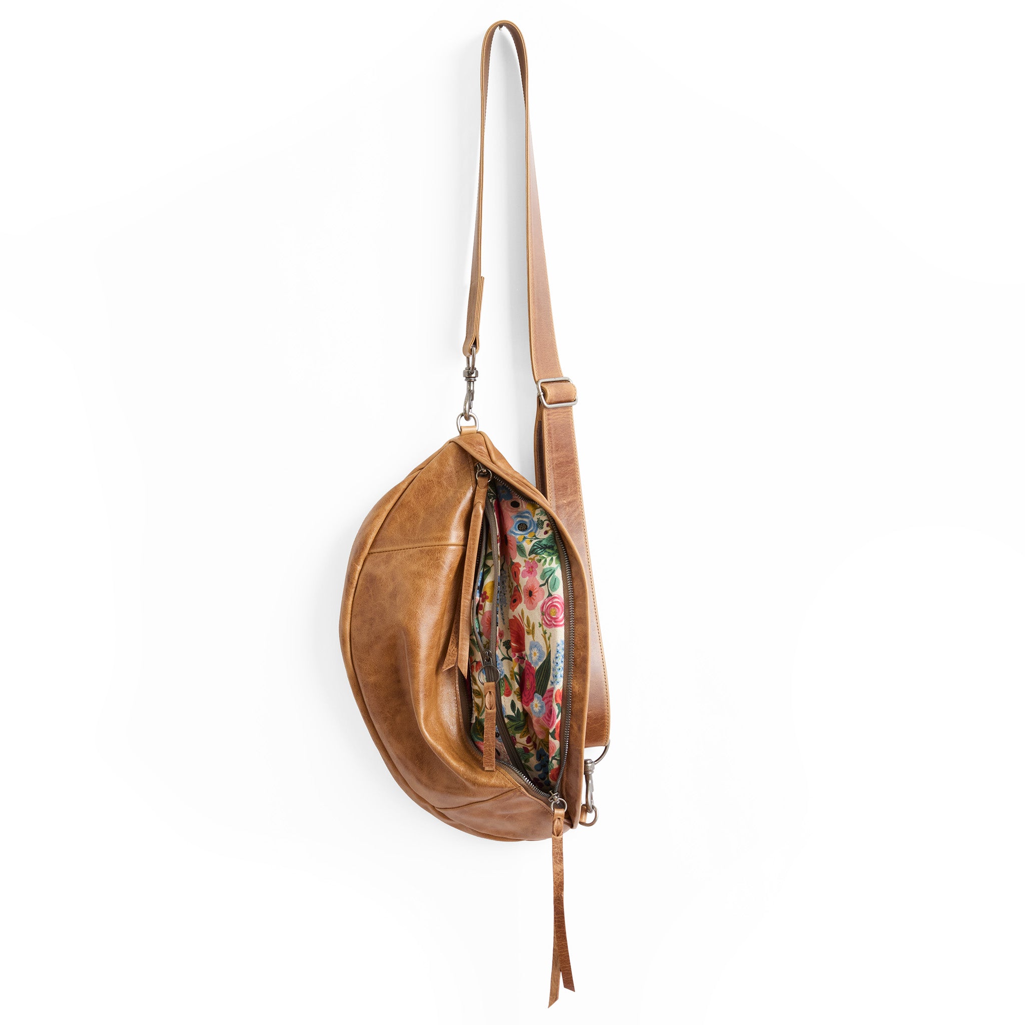 the lissa in light saddle, showcasing interior rifle paper co. garden party coral lining
