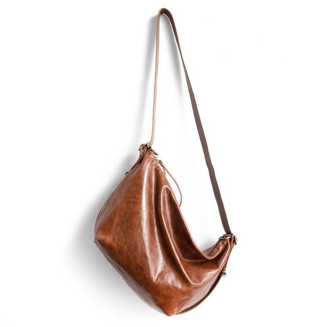 saddle | medium duffel in saddle, showing extended strap