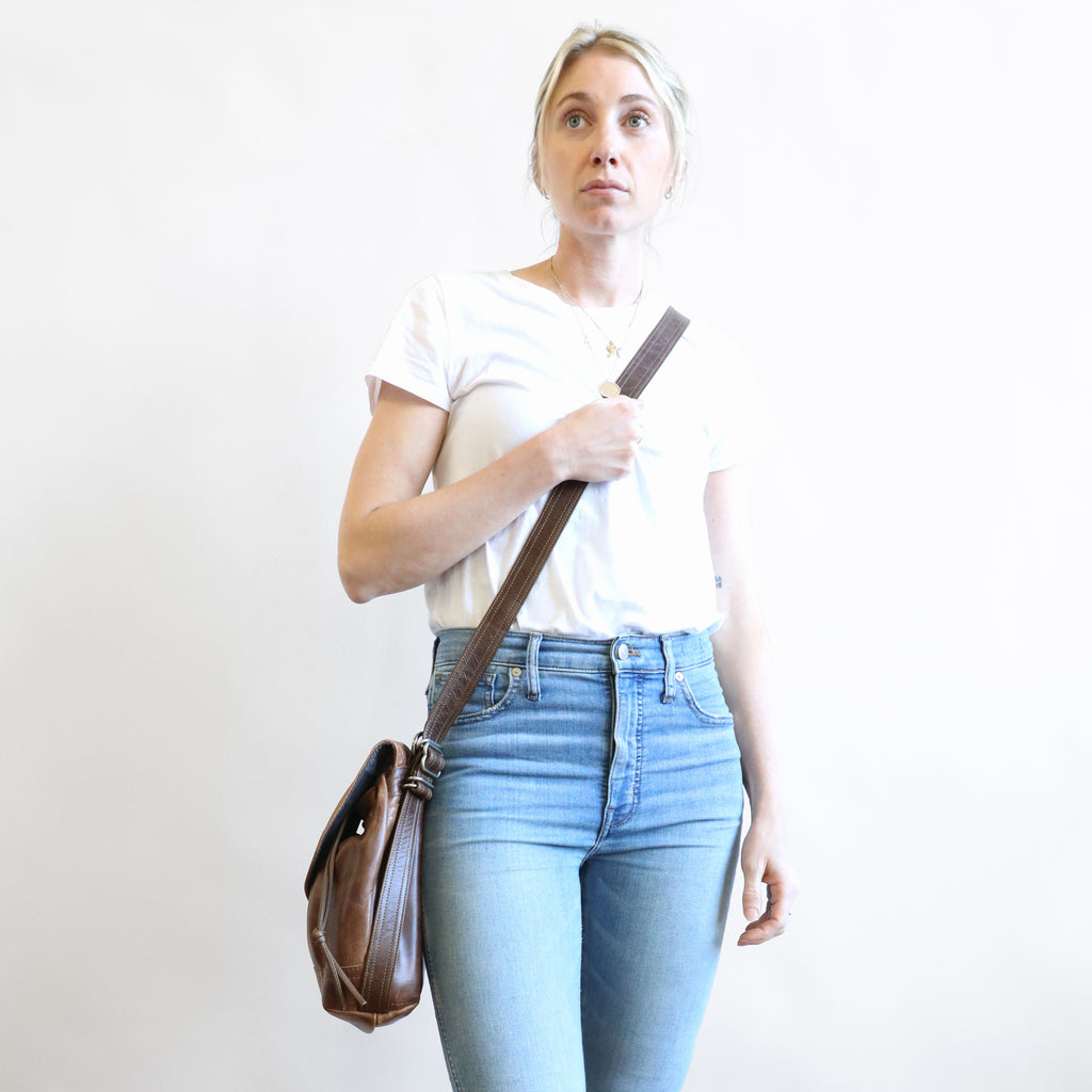 front view of model carrying 1904 maxwell, size small, crossbody. 